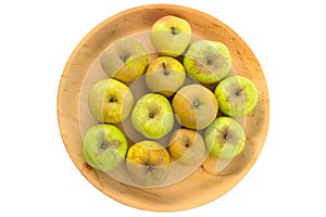 Wooden bowl of imperfect looking organic apples with unconventionally raised method, no GMO techniques.