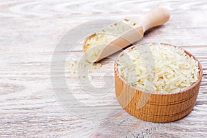 A wooden bowl of long grain white rice