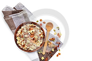 A wooden bowl  Muesli with fruit and nut and a spoon isolated on white background. Healthy breakfast composition with copy space.