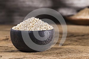 wooden bowl with quinoa grains on the table, chenopodium quinoa