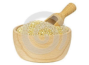 A wooden bowl of quinoa with scoop