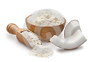 Wooden bowl and scoop full of coconut flour isolated on white