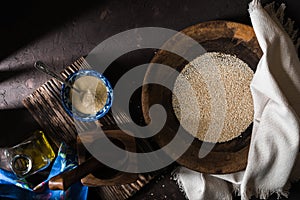 Wooden bowl of sesame seeds and olive oil