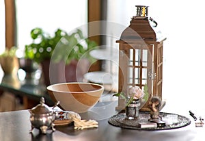 Wooden bowl stands on a sideboard with lantern