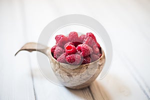 Wooden bowl with summer raspberries