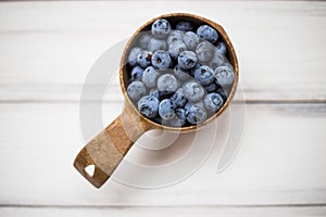 Wooden bowl with sweet summer blueberries