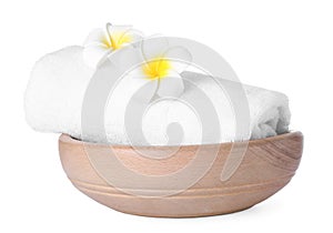 Wooden bowl with towel and flowers on white. Spa supplies