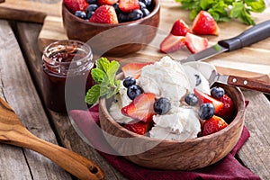 Bowl of Vanilla Ice Cream With Blueberries and Strawberries