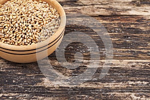 Wooden bowl and wheat grain