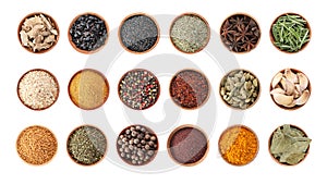 Wooden bowls with different spices and herbs on white background, top view.