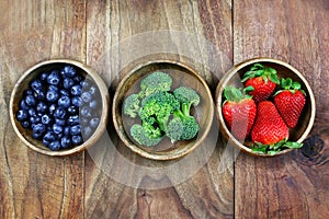 Wooden Bowls Filled With Healthy Fresh Fruit on a Rustic Wooden Background