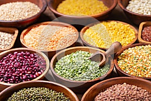 wooden bowls of peas, legumes, lentils, chickpeas, rice and beans
