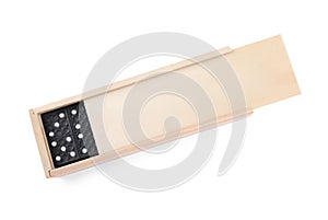 Wooden box with black domino tiles on white background, top view