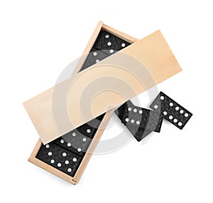 Wooden box with black domino tiles on white background, top view