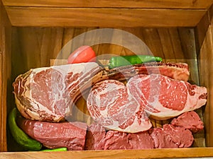Wooden box containing different types of gourmet meat cuts