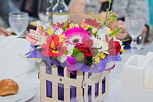 Wooden box with differing flowers made in garden style