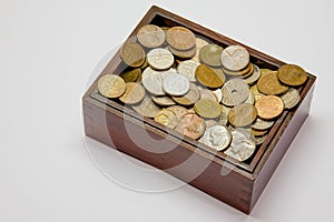 Wooden box filled with various coins
