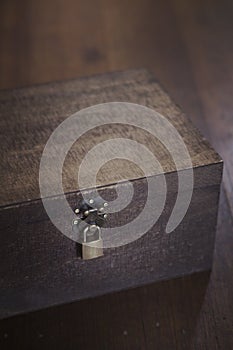 Wooden box on floorboards overhead photo