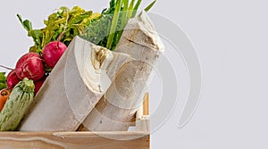 Wooden box with fresh vegetables and organic greens on white background. Bio organic food. Detox diet. Selective focus. Space for
