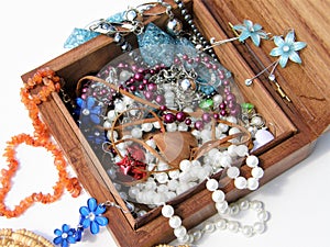 Wooden box with necklaces and earrings inside