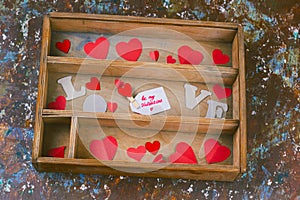 wooden box with paper hearts and