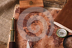 Wooden box, telescope, compass and aged world map