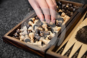 Wooden box with vintage chess pieces, close up.