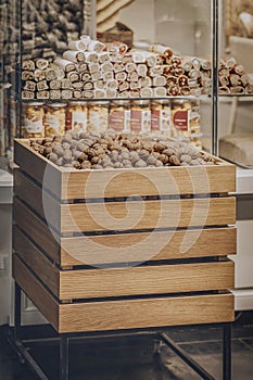 Wooden box with walnuts in the department of a grocery store. Healthy sweets and snacks