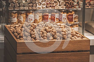 Wooden box with walnuts, food store, healthy sweets and snacks