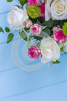 Wooden box with white and pink roses and chrysanthemums on  turquoise wooden board. Decoration of home. Flowers boxes. Wedding