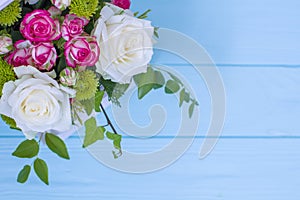 Wooden box with white and pink roses and chrysanthemums on  turquoise wooden board. Decoration of home. Flowers boxes. Wedding