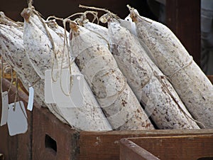 Wooden box with whole tuscan salami sausages