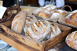 wooden bread basket with freshly baked loaves on display