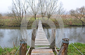 Wooden bridge across the river