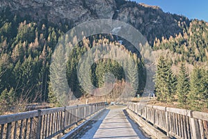 Wooden bridge across a small river in the national park Hohe Tauern, Alps mountains, Austria