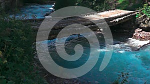 Wooden bridge across stormy mountain river