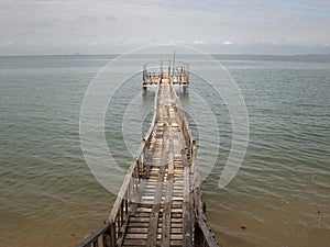 Wooden Bridge from beach to the sea