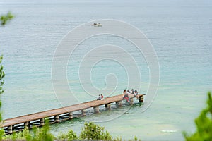 Wooden bridge within a beautiful scenery at Lake Garda in Sirmione, Italy.