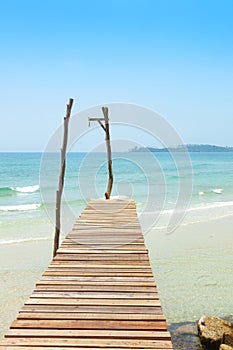 Wooden bridge, corridor to the sea on Beautiful crystal clear se