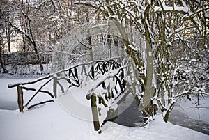 Wooden bridge covered with snow