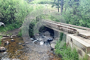 Wooden Bridge Crosses Gentle Stream