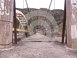 wooden and steel bridge, near mountain photo