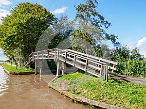 Wooden bridge for cycles and pedestrians by Dokkumer Ee in Bartlehiem, Friesland, Netherlands