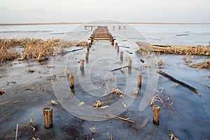 Wooden bridge in frozen lake