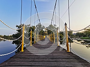wooden bridge hang over the water in swam, Thailand