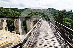 Wooden bridge held by massive rock pillars leads the way into the Neamt Citadel is a medieval fortress located in north-eastern