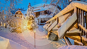 Wooden bridge with house in the night with light in the snow in Saxon Switzerland National Park, Elbe Sandstone Mountains at the B