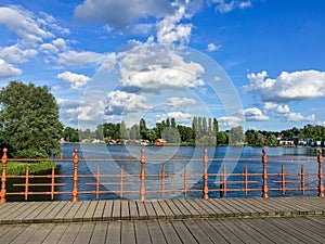 Wooden bridge with iron fence in landscape