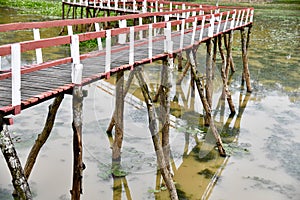 Wooden bridge on a lake around an urban area