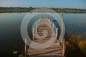 Wooden bridge on the lake. Beautiful landscape overlooking the lake in Coba. Mexico, Yucatan.